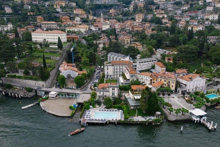 A coastal town with a marina, buildings, and a large body of water. 5