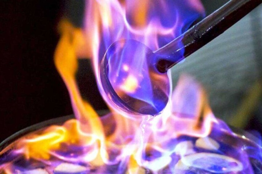 A glass object being heated with a flame. 2