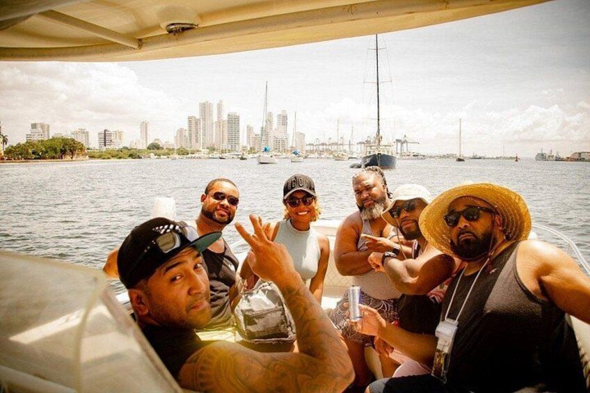 A group of people on a boat with a city skyline in the background. 2