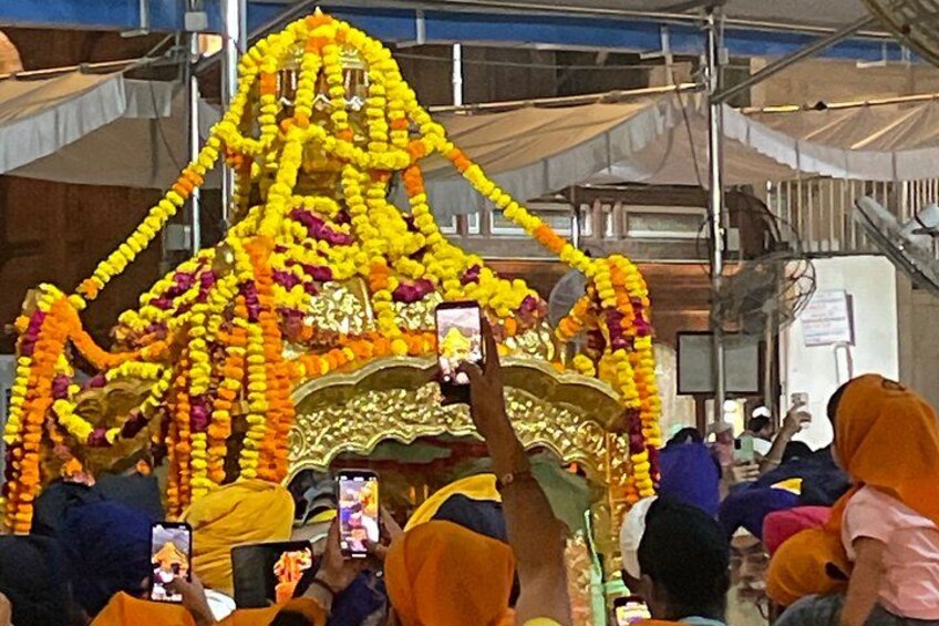 A decorated structure with people taking photos. 2