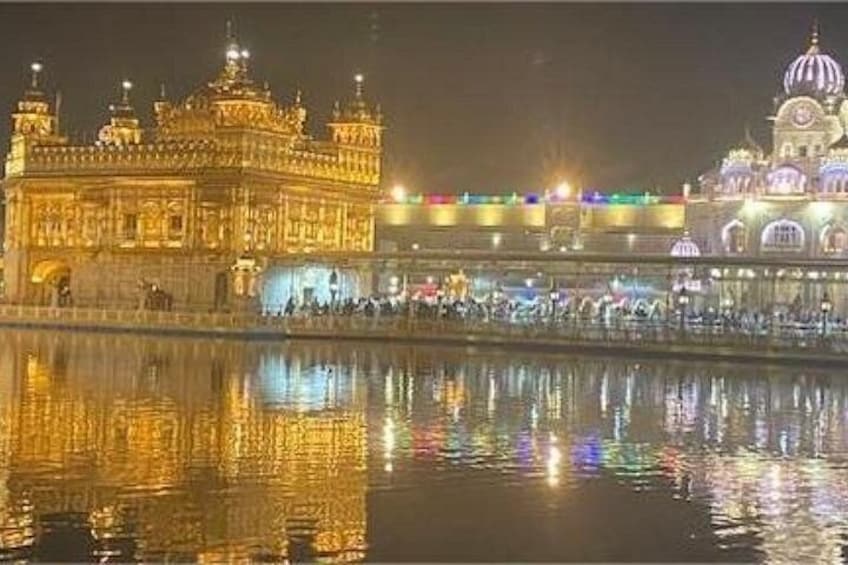 The Golden Temple at night with reflections on water. 5