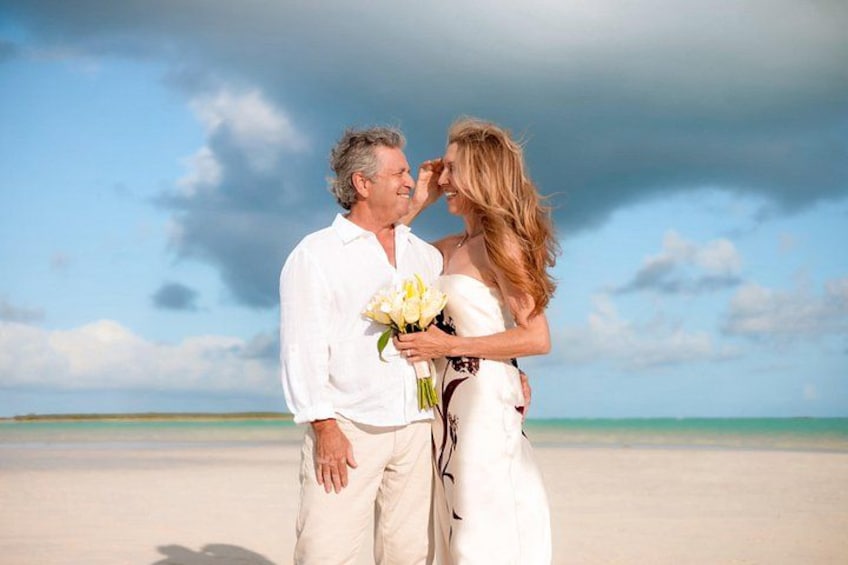 A couple on a beach with a clear sky and calm sea. 4