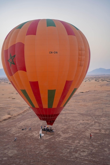 A hot air balloon with the registration CN-DIN in a desert landscape. 2