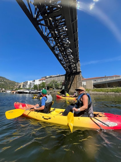 People kayaking under a bridge. 1