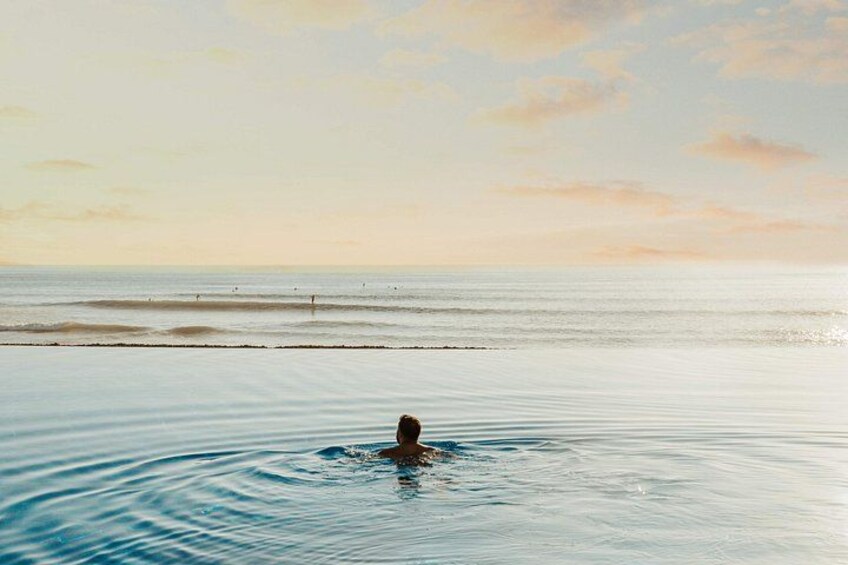 A customer swims to the edge of the pool while watching the sea 3