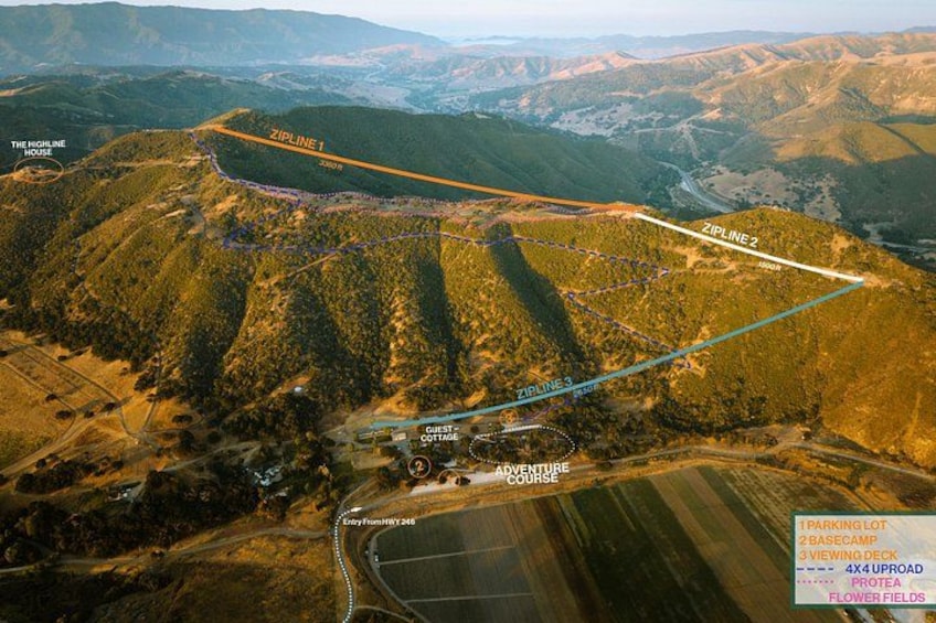 A mountainous landscape with marked zip lines and a guest cottage. 2