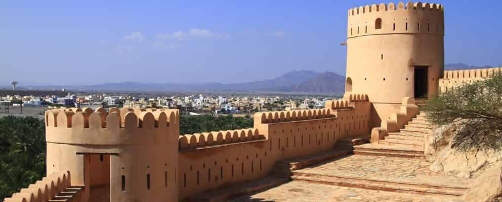 A historic fort with a large tower and a fortified wall. 4