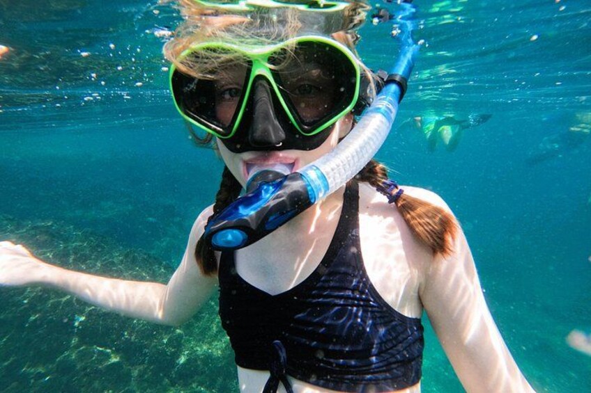 A person snorkeling underwater with a snorkel and mask. 4