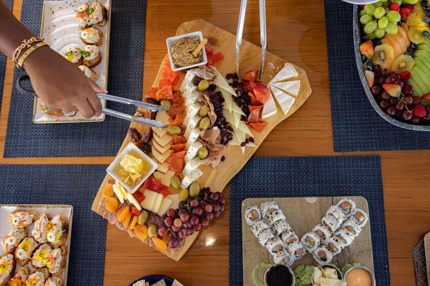 A charcuterie board with various cheeses, fruits, and nuts. 2