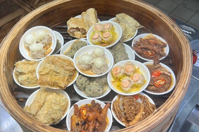 A variety of dim sum dishes in a bamboo steamer. 2