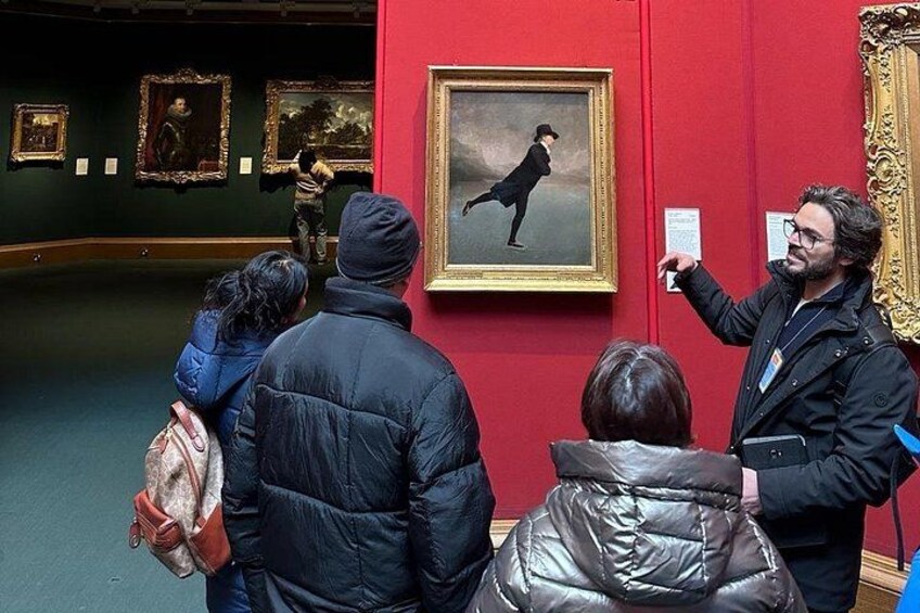 People observing paintings in an art gallery. 3