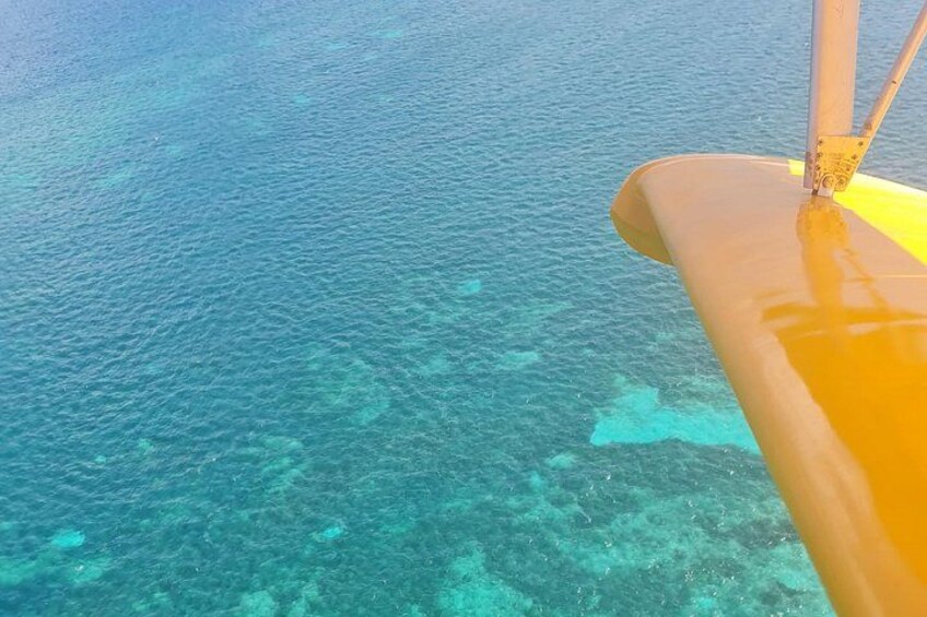 Une mer d’un bleu profond, avec un objet jaune, peut-être un bateau, au premier plan. 2