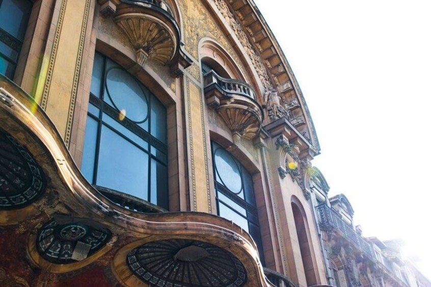 Ornate architectural details, large windows, and decorative elements on a building facade. 2