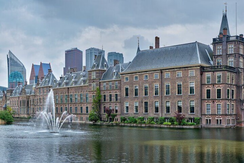 A historic building with a fountain in front, surrounded by modern skyscrapers. 4