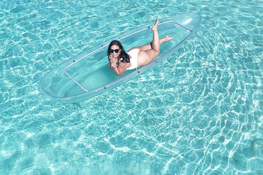 A person floating on a clear blue pool with a transparent edge. 4