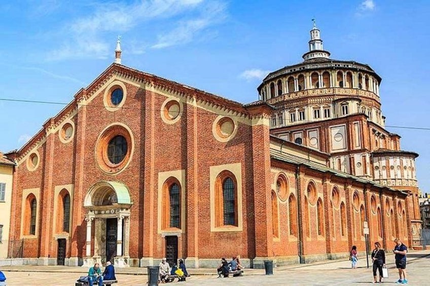 A large brick building with a dome and arched windows. 2
