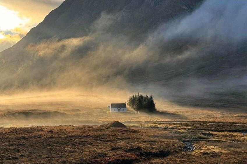 A solitary house in a misty landscape with a mountain in the background. 1