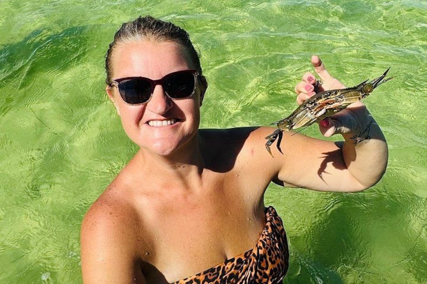 A person in a leopard print swimsuit holding a fish. 2