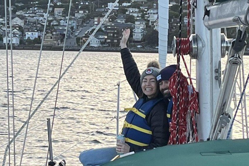 A person on a boat with a cityscape in the background. 3