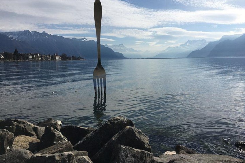 A fork in water with mountains in the background. 1