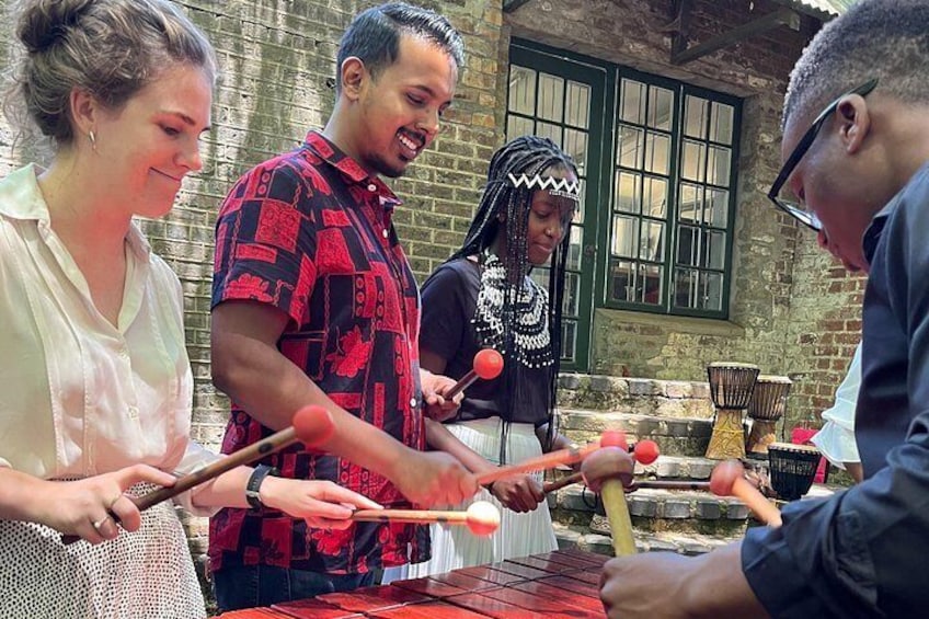 Our expert local facilitators teaching guests how to play the African Marimba 5