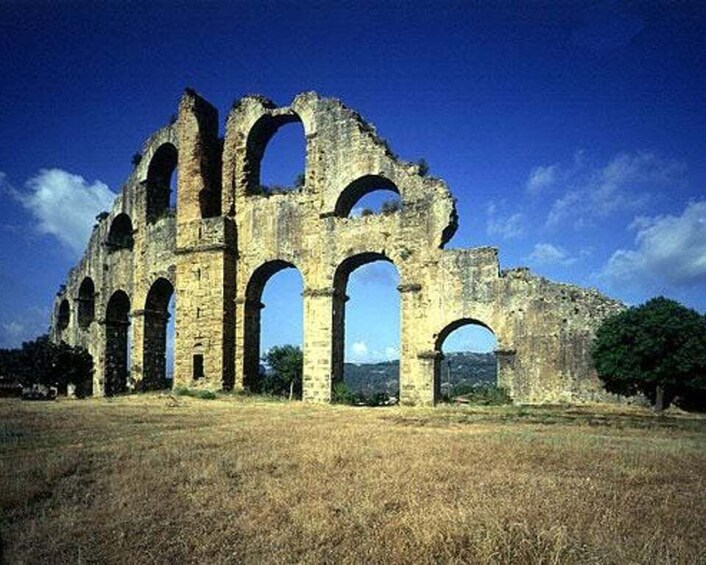 Ancient ruins with multiple arches and columns. 2