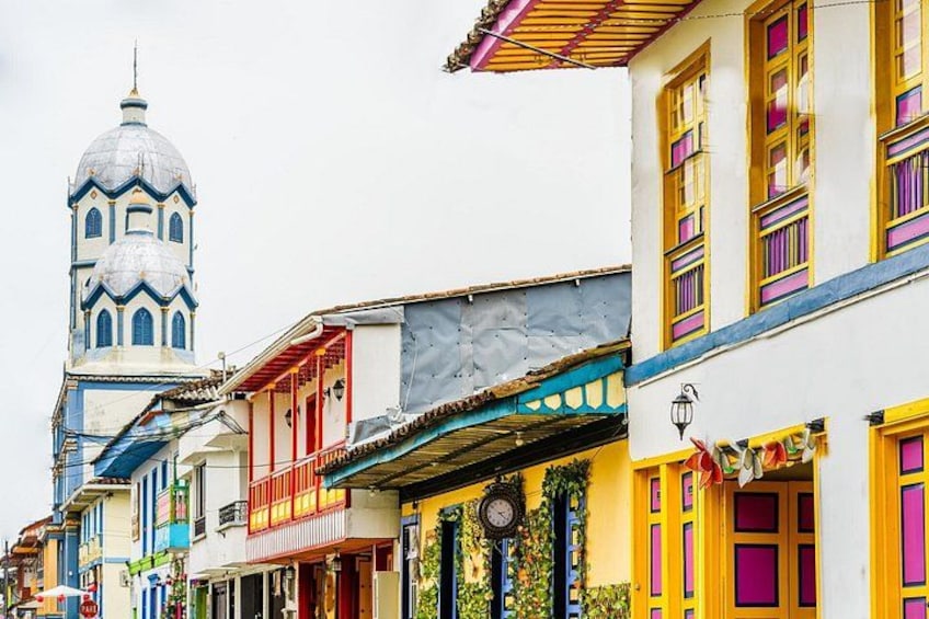 Colorful buildings with a prominent dome and a clock. 3