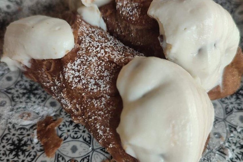 A dessert with whipped cream and powdered sugar. 3