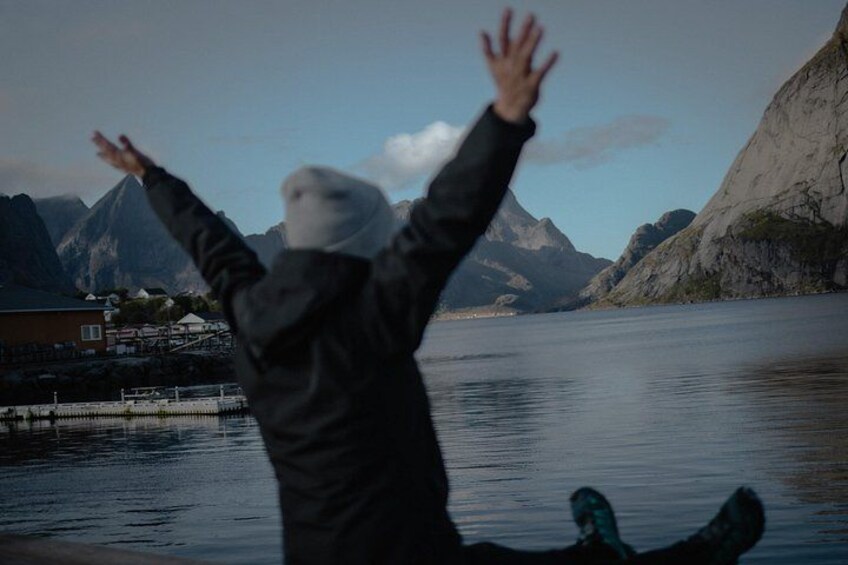 A person jumping into a lake with mountains in the background. 5