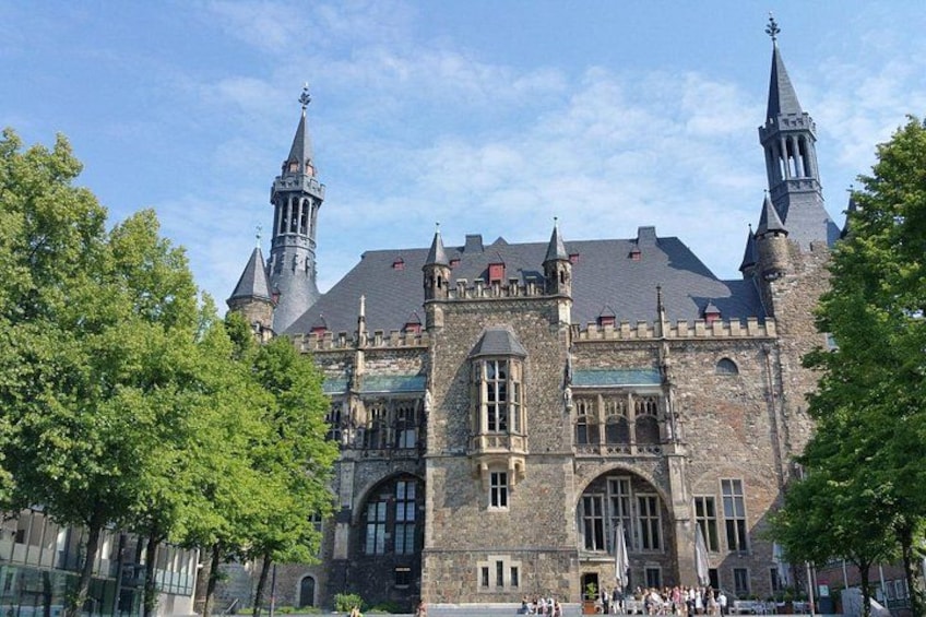 A historic building with a clock tower, arched windows, and a stone facade. 4