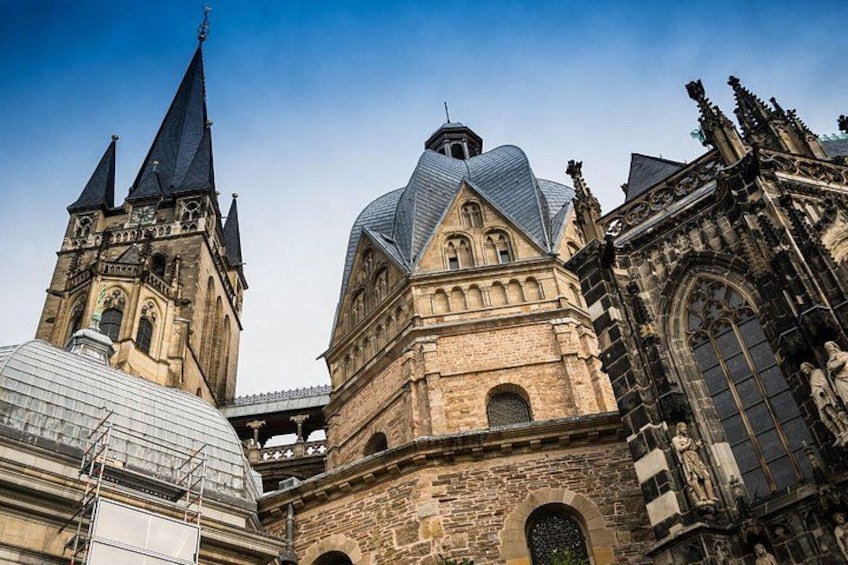 A historic building with pointed towers and a large dome. 2