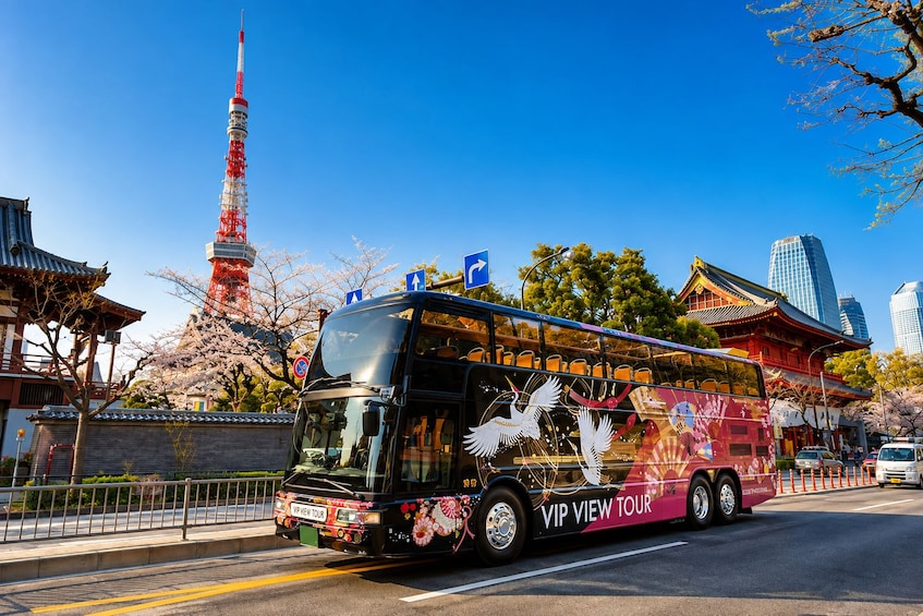 A double-decker bus with 'VIP VIEW TOUR' written on the side, parked on a street with cherry blossoms, a traditional Japanese building, and a red tower in the background. 2