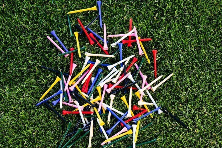 A pile of colorful plastic sticks on a grassy field. 5