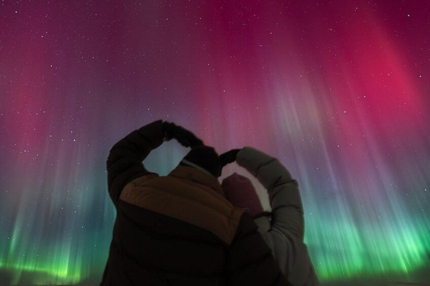 A person taking a photo of the aurora borealis. 3