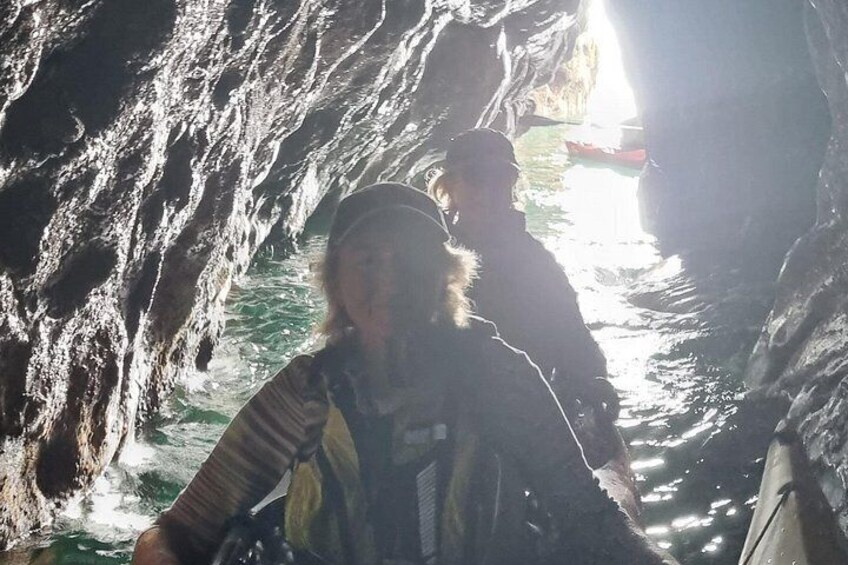 A person in a cave with water flowing through it. 2
