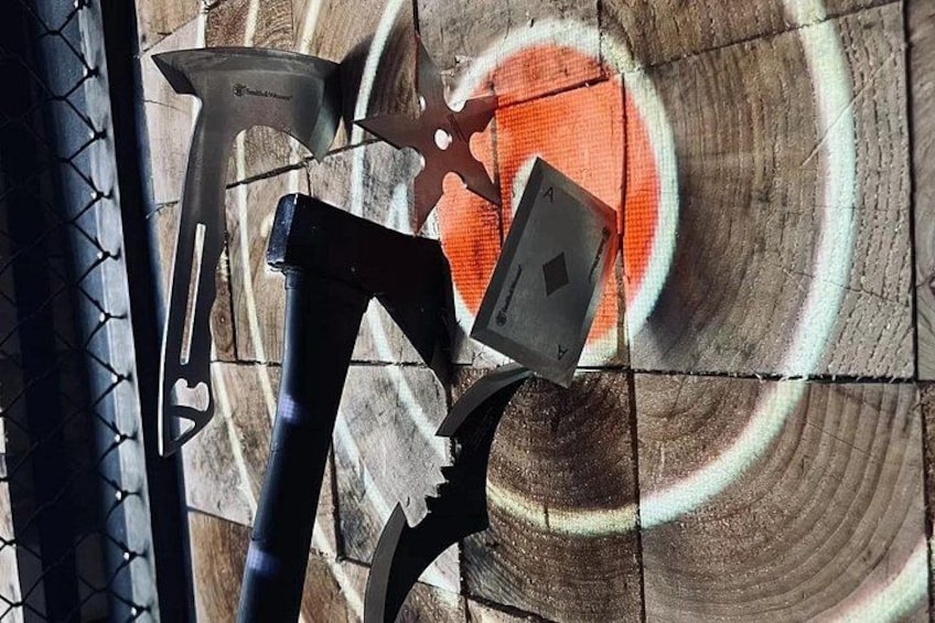 A wooden surface with a circular pattern and two axes. 4
