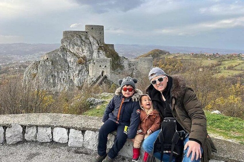 Bonding moments at their best! A father and his two boys share smiles and joy against the breathtaking backdrop of Srebrenik Fortress. Seated on a rock, 200 meters from this historical monument. 5
