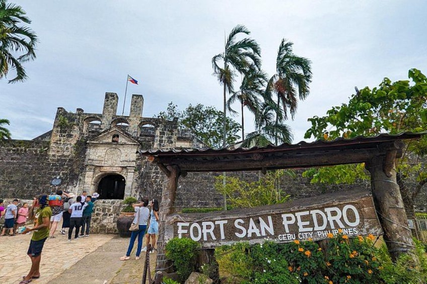 A historical fort entrance with a sign reading 'FORT SAN PEDRO CEBU CITY PHILIPPINES.' 3