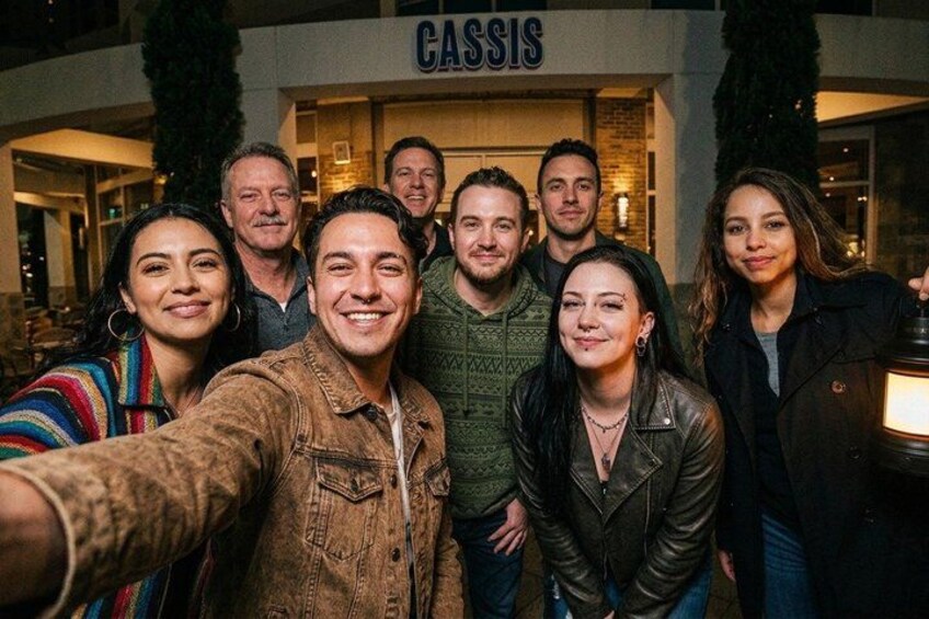 A group of people posing in front of a building labeled 'CASSIS.' 2