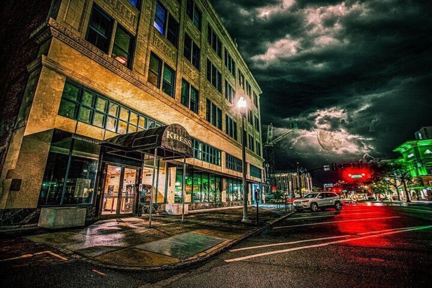 A building with a sign that reads 'KRESS' at night. 3