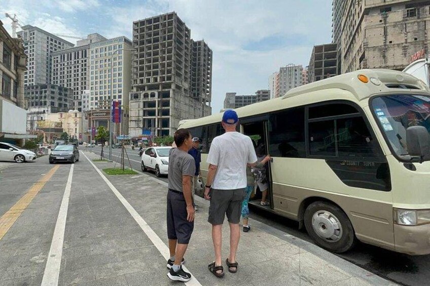 A city street with a bus, buildings, and a few cars. 4