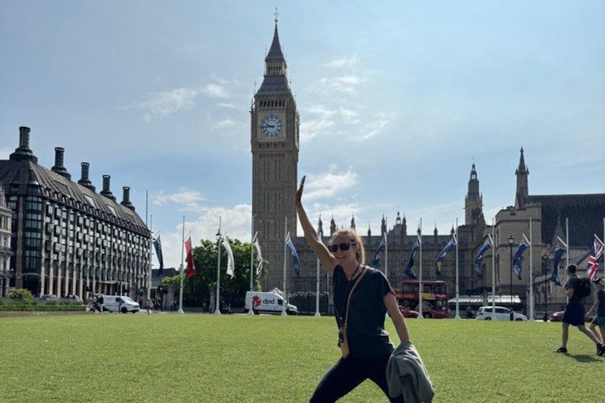 A person in a grassy area with the Big Ben clock tower in the background. 5
