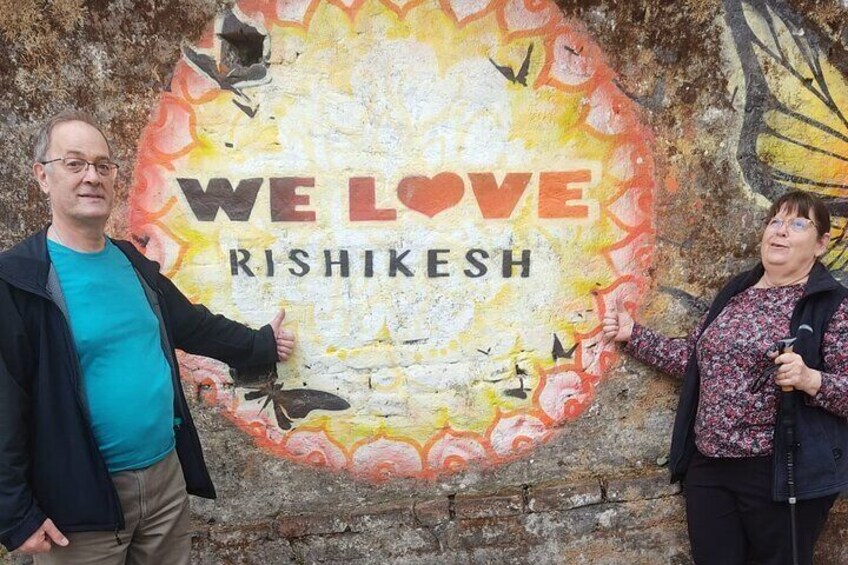 A mural with 'WE LOVE RISHIKESH' text and a butterfly. 3