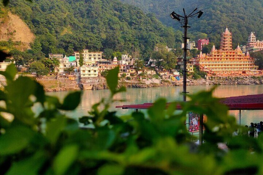 A riverside town with a prominent temple and residential buildings. 1