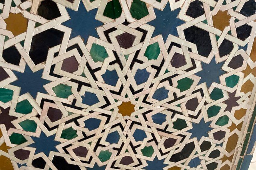 A detailed mosaic with geometric patterns and star shapes. 4