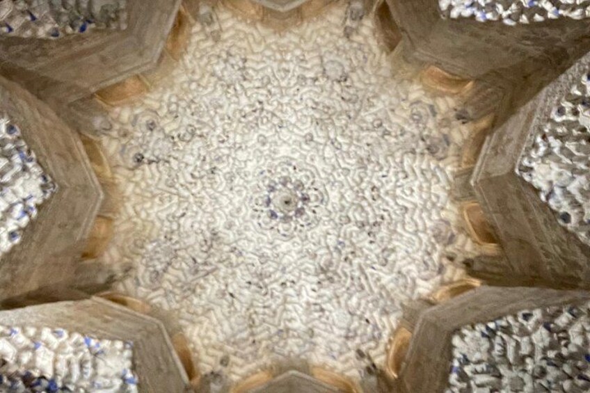 A symmetrical, kaleidoscopic pattern with a central focal point and repeating geometric shapes. 5