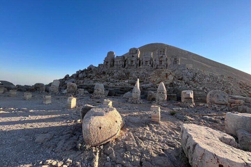 Ancient ruins with stone structures and columns on a hill. 4