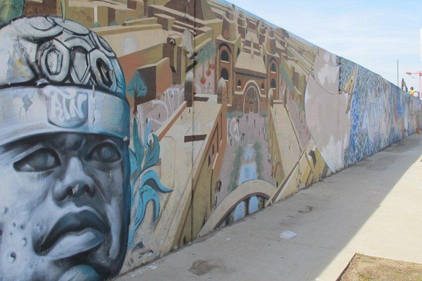 A mural with architectural elements and a sidewalk. 4
