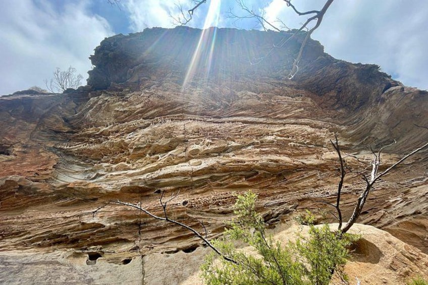 A layered rock formation with a clear sky. 4