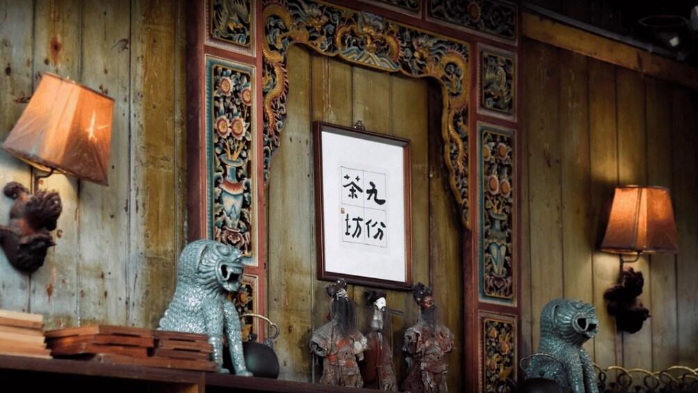 A traditional interior with wooden paneling, decorative wall art, and cultural artifacts. 3
